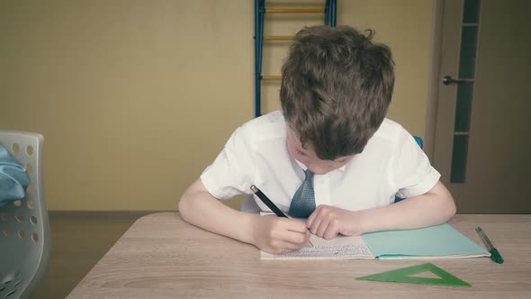 Travelling: Pupils, Little Boys, Do Their Homework. One of Them Makes a Drawing in a Notebook