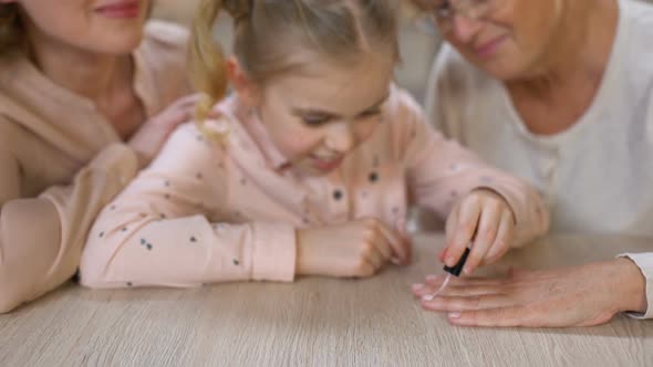 Little Girl Painting Grandmother Nails Doing Manicure, Female Beauty, Leisure