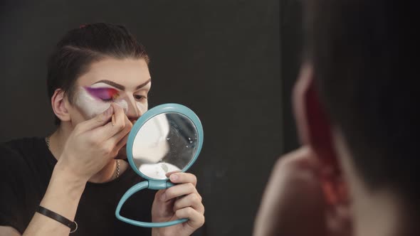 Drag Artist  Young Man Applying Red Eyeshadows on the Inner Corner