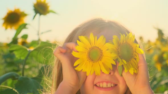 Girl Playing and Having Fun in a Sunflower Field