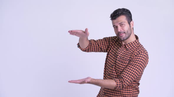 Happy Bearded Persian Hipster Man Snapping Fingers and Showing Something