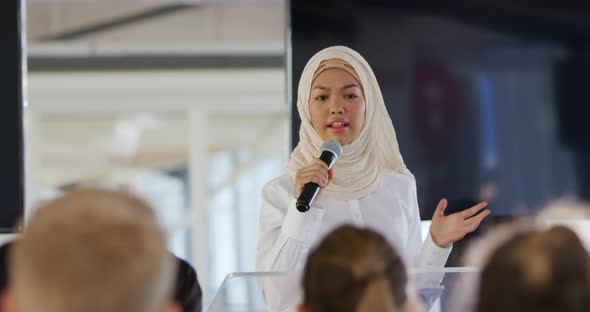 Speaker addressing the audience at a business conference