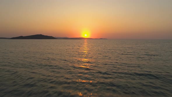 Drone Flying To Sun Going in the Sea Horizon at Scenic Sunset