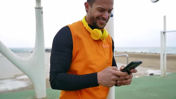 Man training at the beach outdoor gym