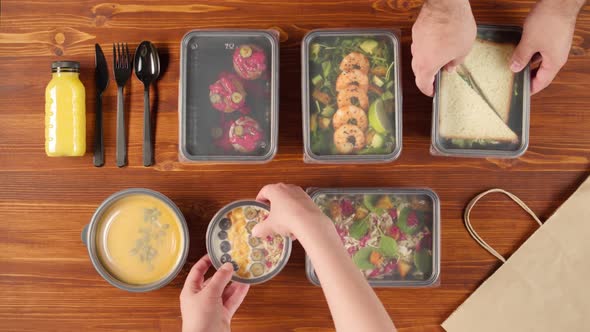 Food Delivery Top View Packaging Take Away Meals in Disposable Containers on Wooden Table