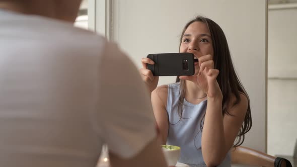 Young Happy Woman Casually Talking with Young Man at the Coffee Shop