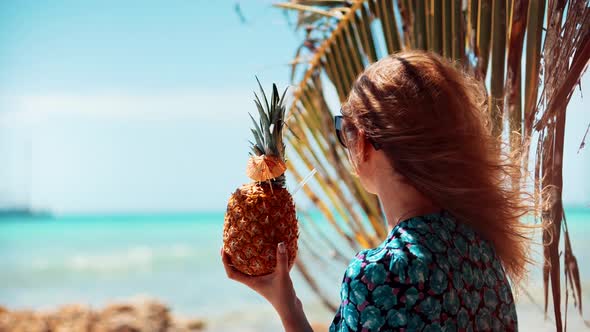 Tropical Beach Happy Female.Girl Drinking Pina Colada On Tropical Beach.Blonde Travel Girl Relaxing