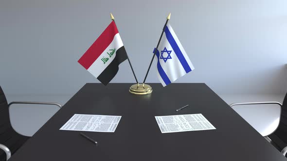 Flags of Iraq and Israel on the Table