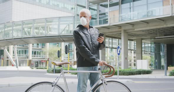 Caucasian man out and about in the city street wearing a face mask against coronavirus