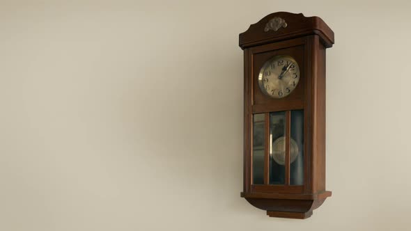 Vintage Clock On Wall With Swinging Pendulum