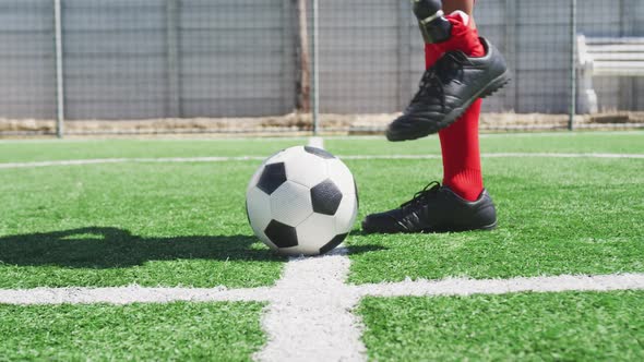 Soccer player with prosthetic leg on field