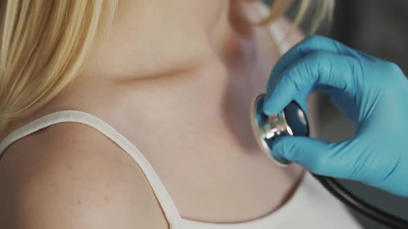 A Female Doctor Is Listening To a Baby Lungs with a Phonendoscope