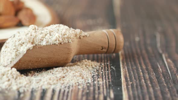 Almond Powder in a Wooden Spoon on Table