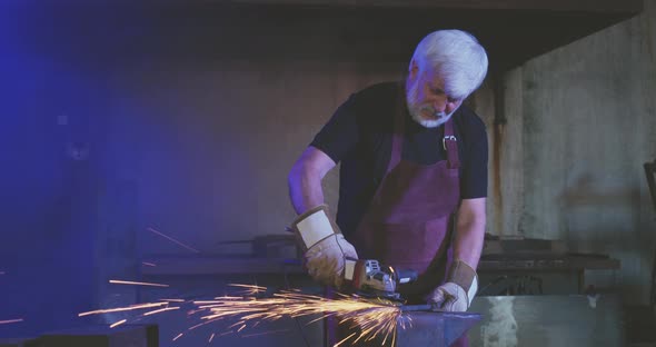 Old Man with Grey Hair Working As Blacksmith