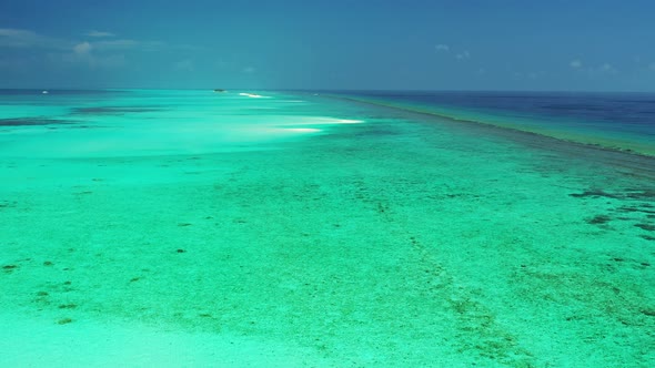 Beautiful fly over abstract shot of a white sand paradise beach and aqua blue ocean background in vi