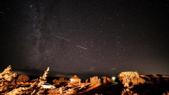 Time lapse of lights moving around campsite at night