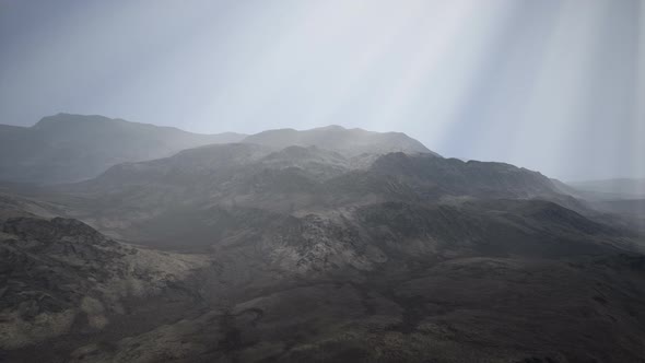Sun Rays Against the Backdrop of the Mountains alt