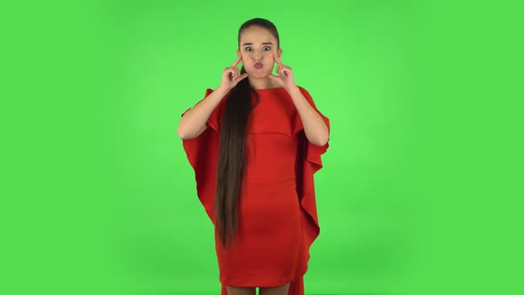 Pretty Young Woman Is Posing for Camera and Making Funny Faces . Green Screen