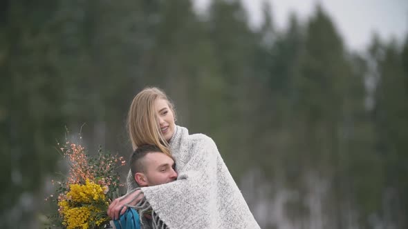 Man Holds His Wife in His Arms