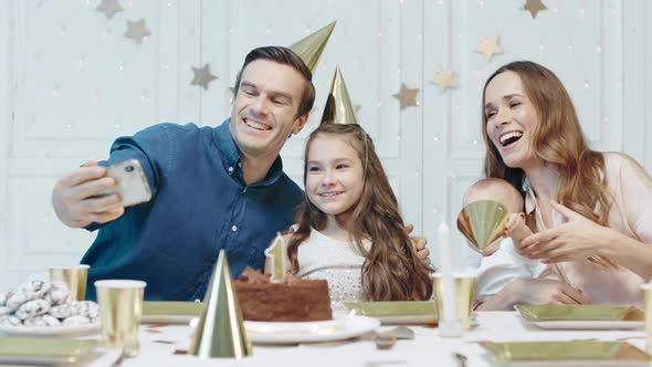 Cheerful People Celebrating One Year Birthday in Party Hat Together.