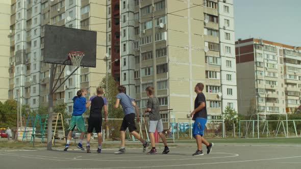 Streetball Player Making Successful Assist on Court