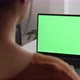 Young Asian woman using laptop computer at home with green blank monitor screen. - VideoHive Item for Sale