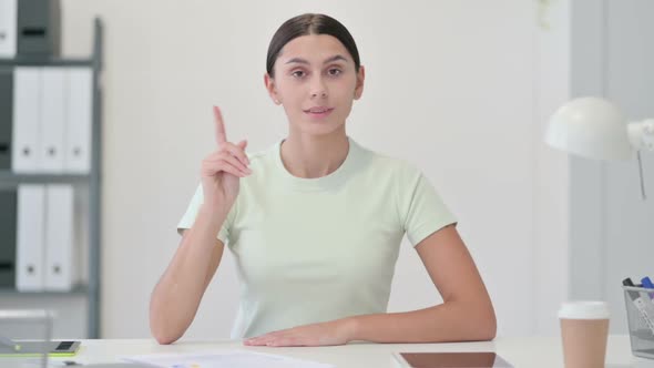 Rejecting Young Latin Woman Shaking Head for No in Office