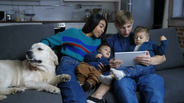 Family with Pet Dog Browsing Online on Tablet Pc