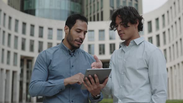 Multiracial Businessmen Using Digital Tablet on Street