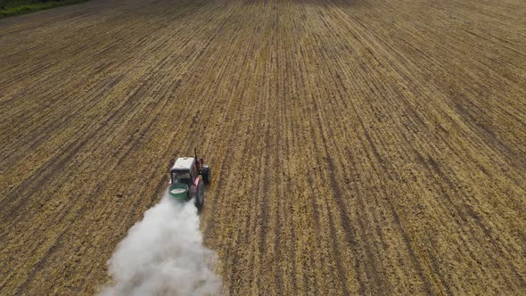 The Tractor Spreads Mineral Fertilizers To Improve The Harvest  