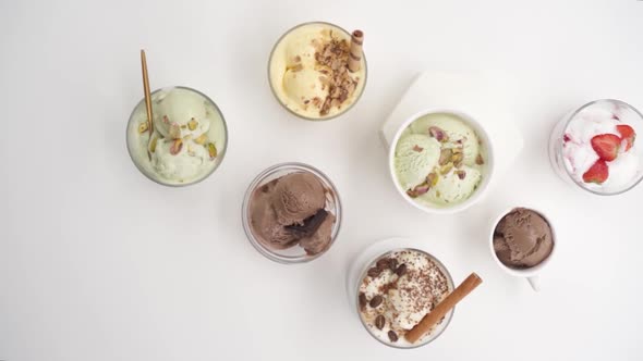 Vertical video: Set of different flavors of ice cream in glasses