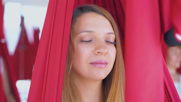 Concentrated on Meditation Young Woman Relaxes in Hammock