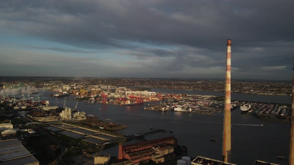 Drone Flying Towards Dublin Port In Ireland With View Of Poolbeg Generating Station Chimneys On A Da