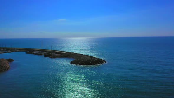 071_ojra.uas_Port_FrontalTraveling_AerialViewGroyne_SunnyDay_4k. General plane aerial view of the ha