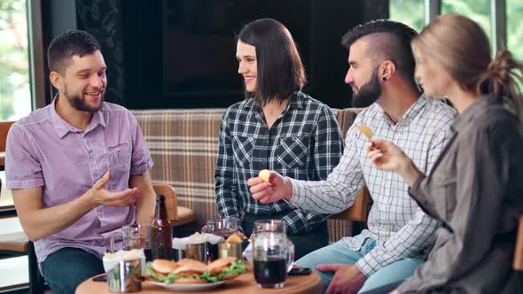 Group of Young Carefree Friend Enjoying Weekend Having Fun at Pub Relaxing Together