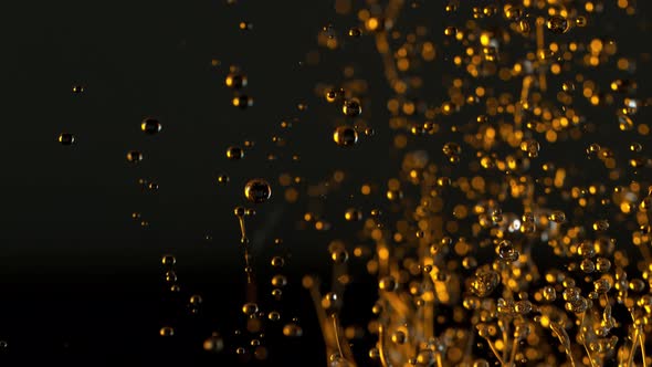 Super Slow Motion Shot of Splashing Oil Isolated on Black Background at 1000Fps