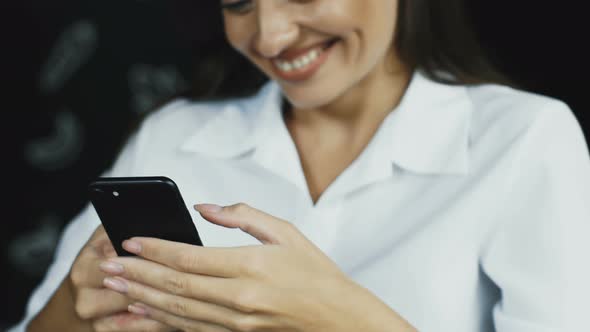 Close up of Woman Texting on Her Phone and Laughing