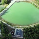 Aerial cinematic footage of the green lake in the forest - VideoHive Item for Sale