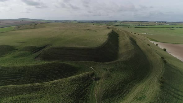 Aerial tracking around the edge of Maiden castle, an Iron age hill fort. Shotes from the old eastern