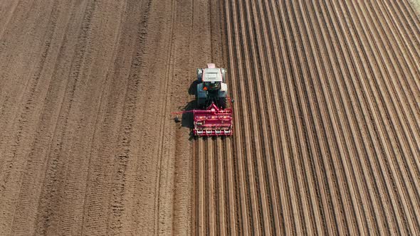 Tractor with Disc Harrows on the Farmland