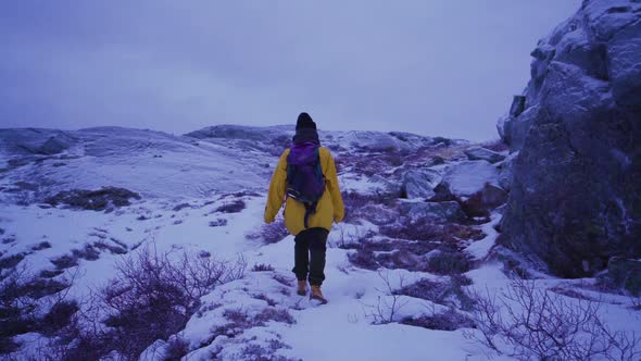 Hiking on a snowy mountain in winter. Person hiker going through deep snow.