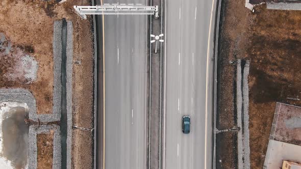 Cars Drive Under Payment Point Gateway on Road with Barriers