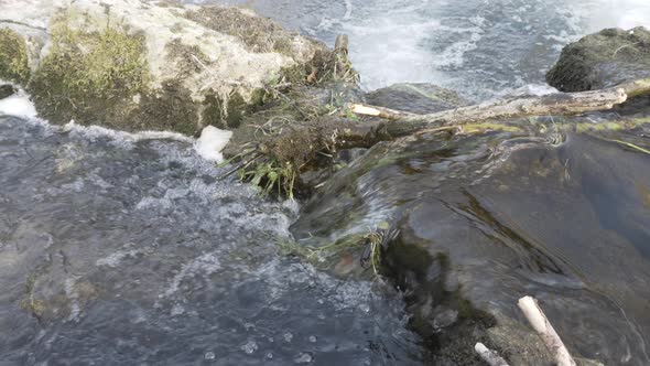 High angle look at water flowing over rocks on the River Wye in Bakewell