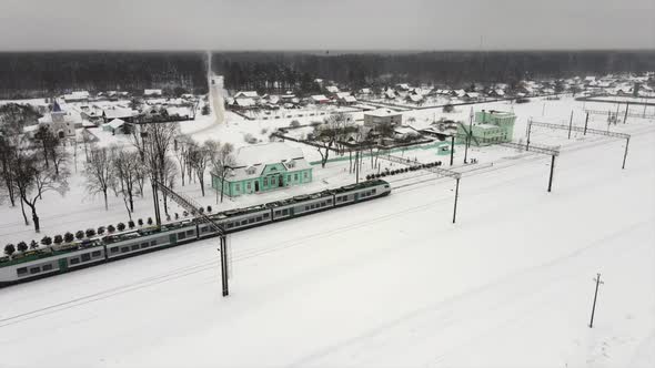 Intercity Modern Electric Train Rides on Snowcovered Rails