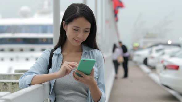 Woman using cellphone in Hong Kong city