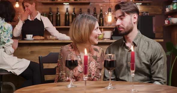 A Young Man Receives a Present From His Girlfriend During a Date