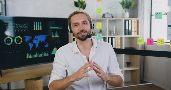 Office Manager in Headset talking into camera with online audience