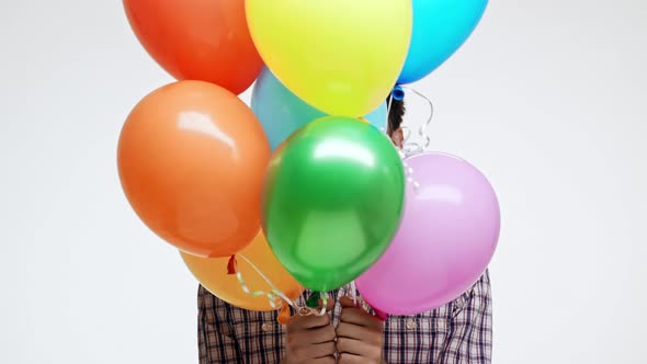 Funny Young Caucasian Male with Dark Hair and Light Bristle Wearing Birthday Cap Cheerfully Hiding