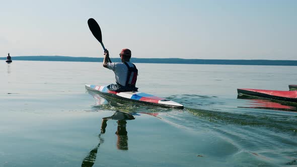 A Lake with Canoes Running Across It