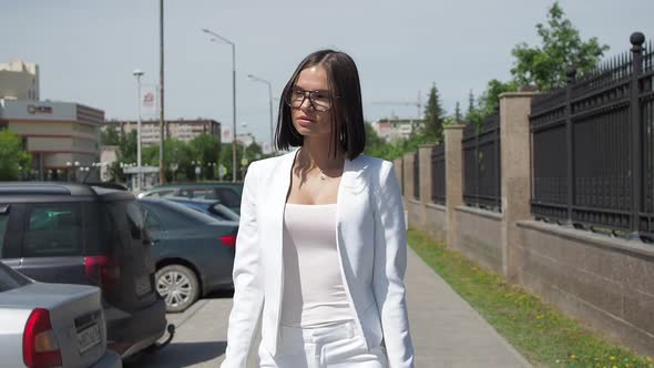 Stylish Woman Walking on Path in Park